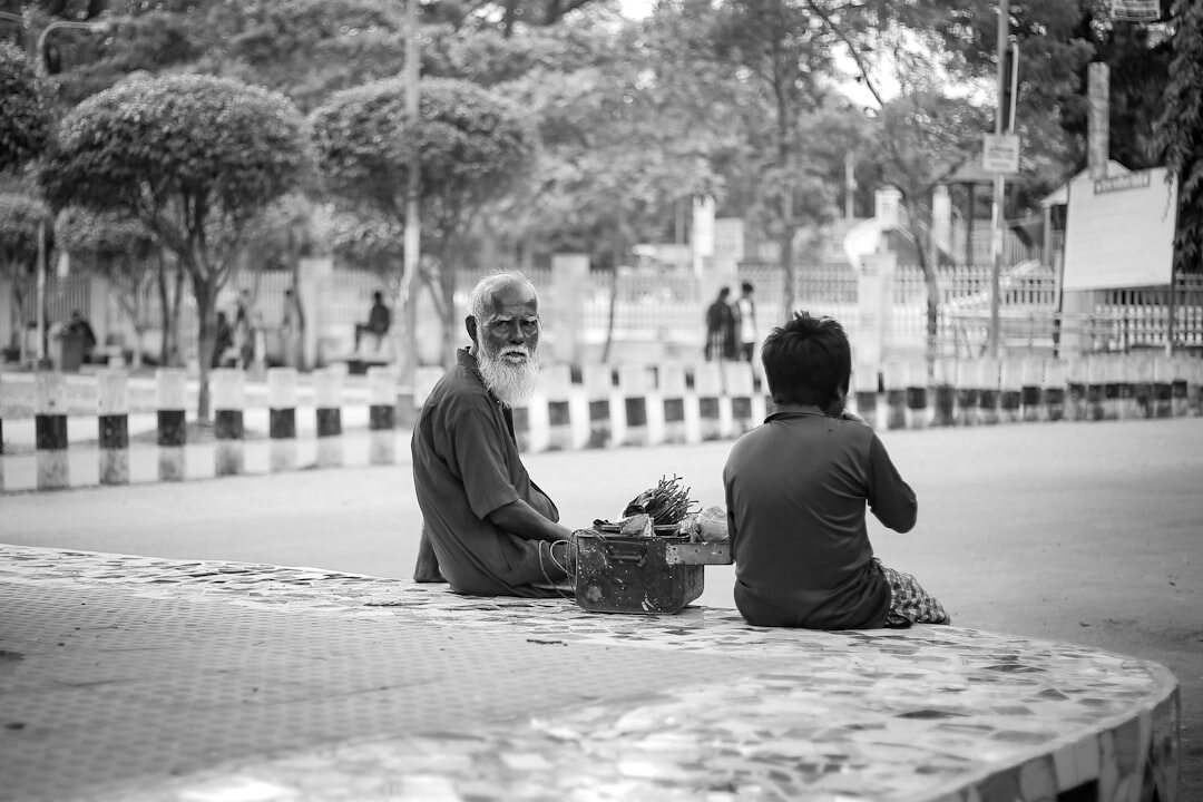 Documentary photographer interviewing an elderly local resident