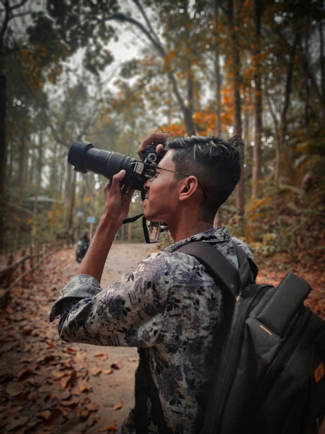 Portrait of a Danish documentary photographer holding a camera